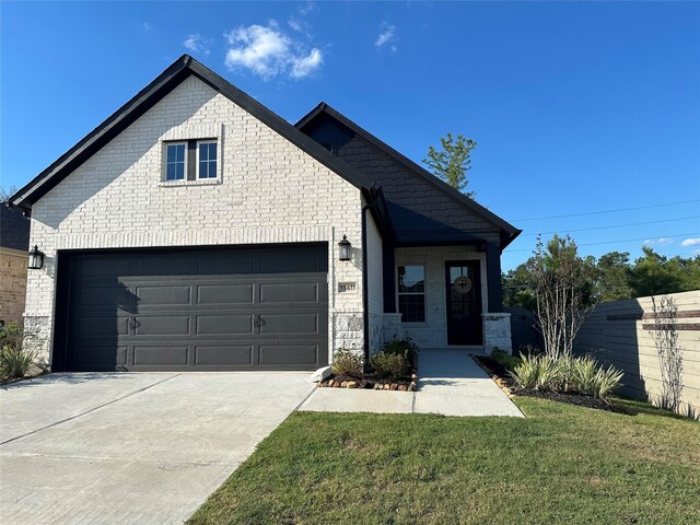 view of front of house featuring a garage and a front lawn