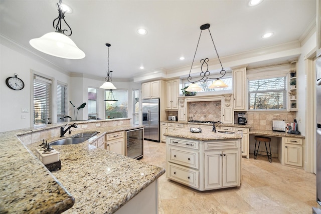 kitchen featuring a large island, light stone counters, beverage cooler, stainless steel fridge, and pendant lighting