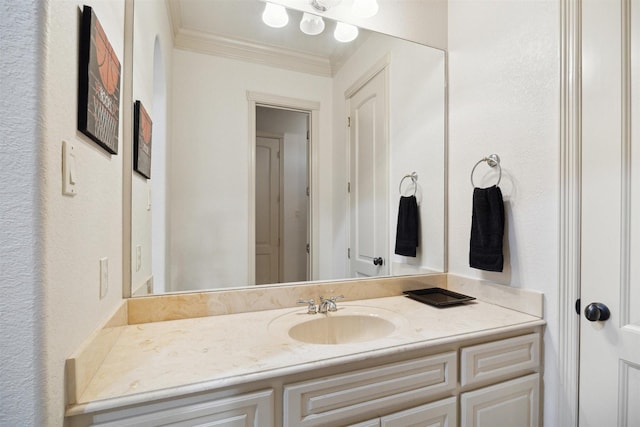 bathroom with vanity and ornamental molding