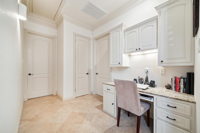 office space with built in desk and ornamental molding