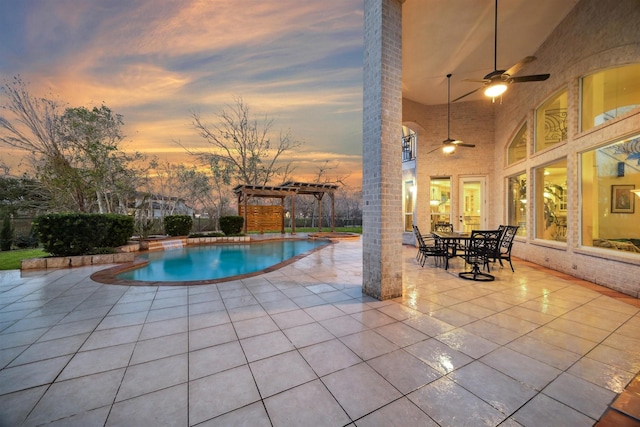 pool at dusk with ceiling fan, a pergola, and a patio area