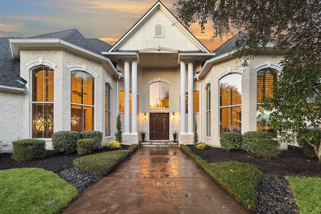 view of exterior entry at dusk