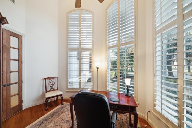 home office with hardwood / wood-style flooring and a healthy amount of sunlight