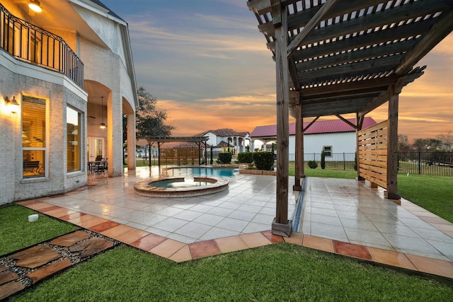 patio terrace at dusk with a pergola and a swimming pool with hot tub