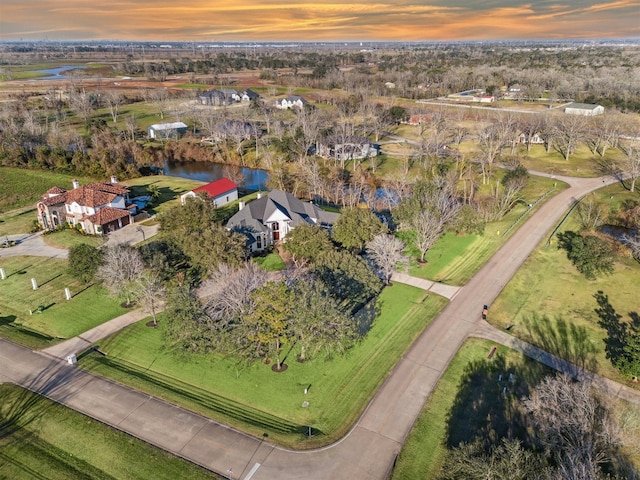 aerial view at dusk with a water view