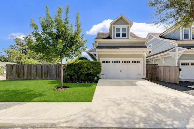 view of front of home featuring a front yard and a garage