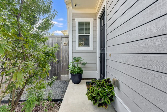 entrance to property featuring fence