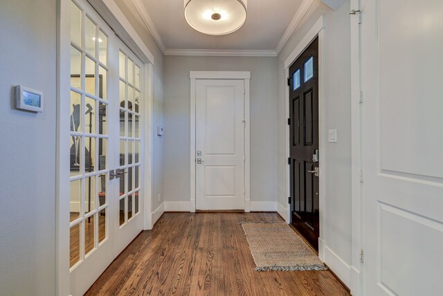 entryway featuring dark wood-style flooring, crown molding, baseboards, and french doors