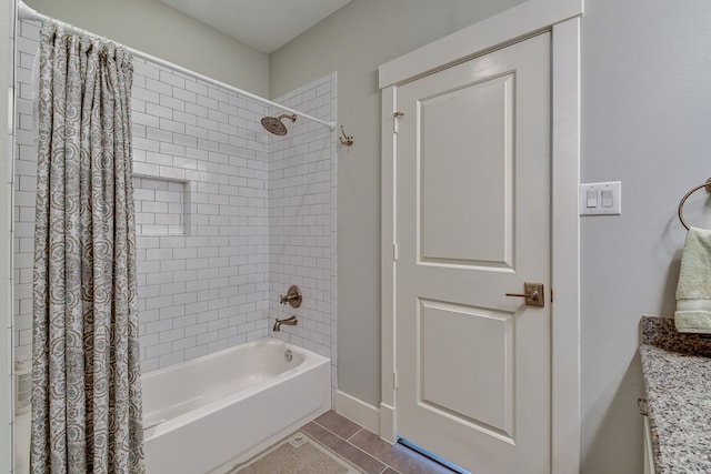 full bathroom featuring tile patterned flooring, baseboards, shower / bathtub combination with curtain, and vanity