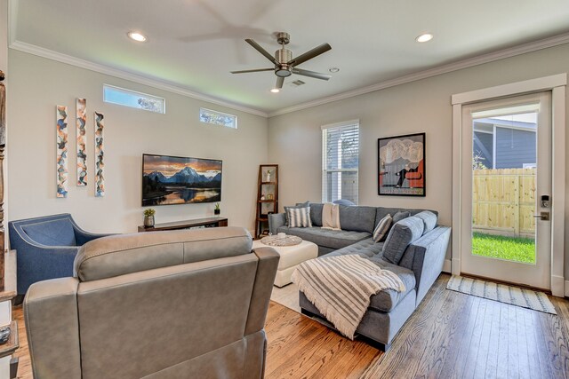 living area featuring light wood-style floors, visible vents, ornamental molding, and recessed lighting