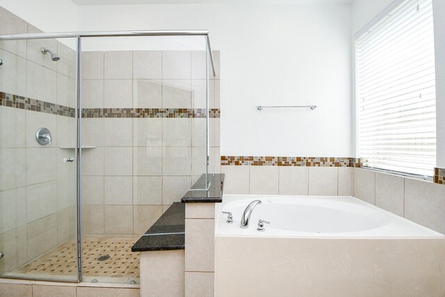 bathroom with separate shower and tub