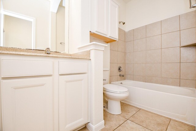 bathroom featuring toilet, tile patterned floors, and tiled shower / bath