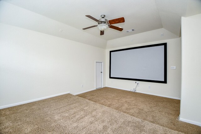 home theater room featuring carpet, vaulted ceiling, and ceiling fan