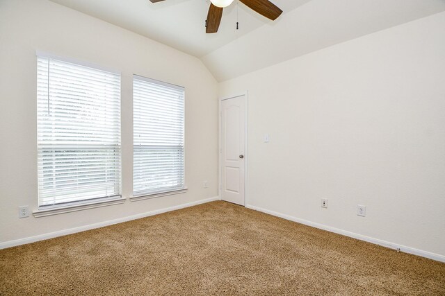 carpeted empty room featuring ceiling fan and lofted ceiling