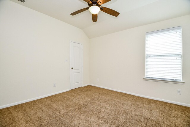 unfurnished room with ceiling fan, carpet floors, and vaulted ceiling