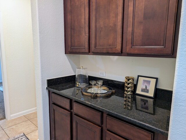 kitchen featuring dark stone countertops and light tile patterned floors