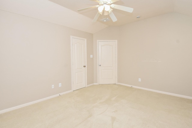 carpeted empty room with ceiling fan and lofted ceiling