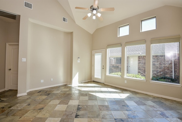 spare room with ceiling fan and high vaulted ceiling