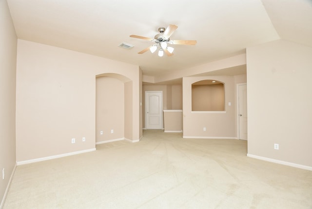 carpeted spare room with ceiling fan and lofted ceiling