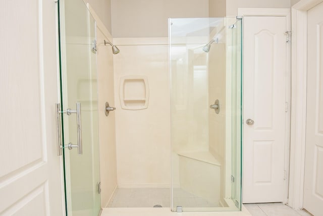 bathroom with tile patterned floors and walk in shower