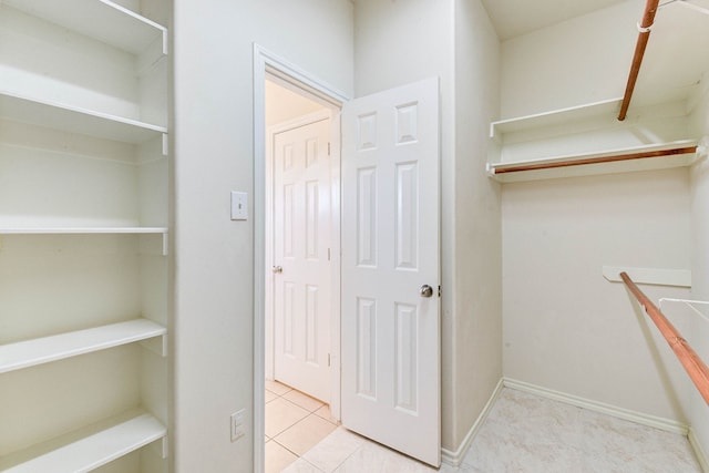 spacious closet with light tile patterned flooring