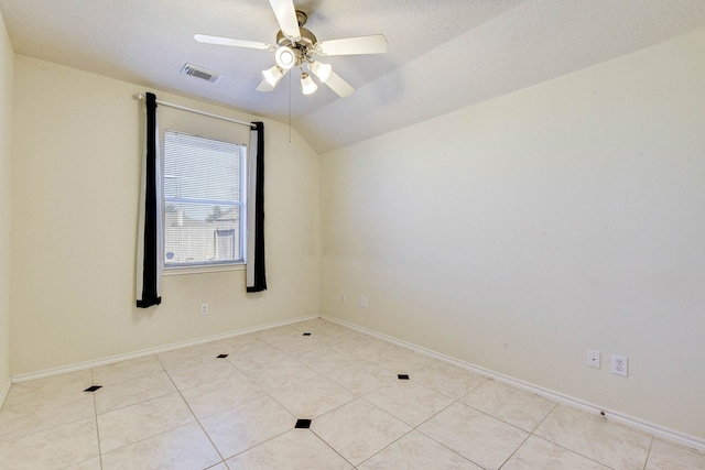 unfurnished room with a textured ceiling, ceiling fan, lofted ceiling, and light tile patterned flooring