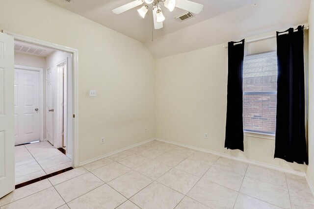 unfurnished room with light tile patterned floors, ceiling fan, and lofted ceiling