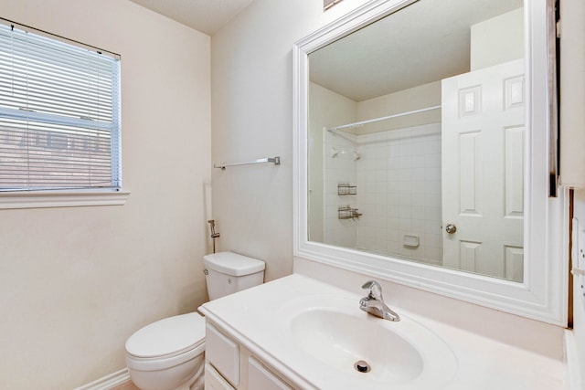 bathroom with walk in shower, vanity, and toilet