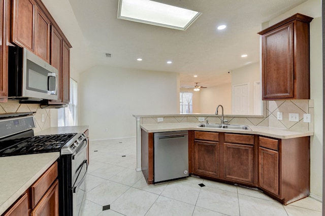 kitchen with backsplash, stainless steel appliances, ceiling fan, sink, and light tile patterned floors