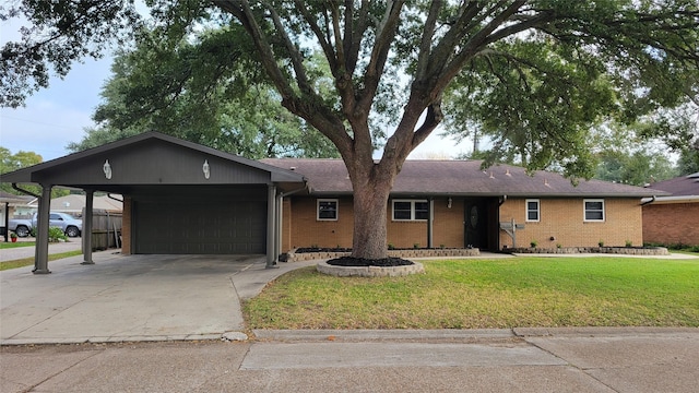 ranch-style house featuring a front lawn, a garage, and a carport