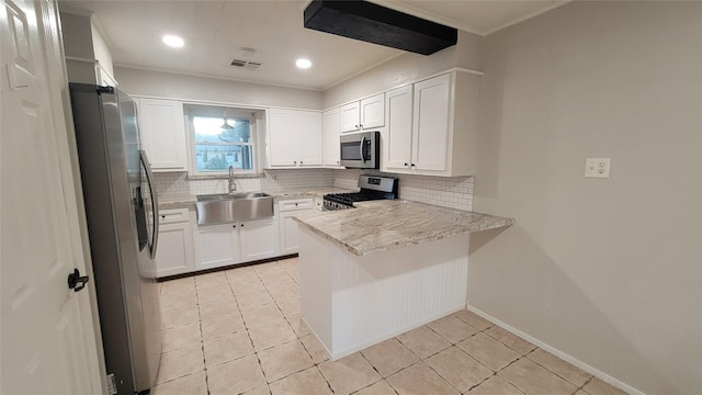 kitchen featuring white cabinets, sink, light stone counters, kitchen peninsula, and stainless steel appliances