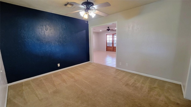 unfurnished room featuring ceiling fan and light carpet