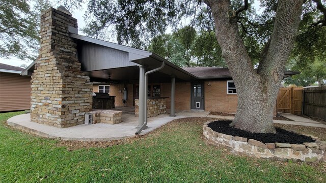 rear view of house with a yard and a patio area