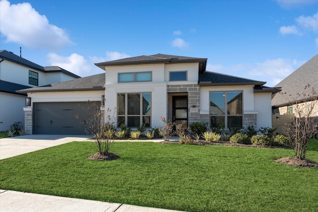 prairie-style home with a garage and a front lawn