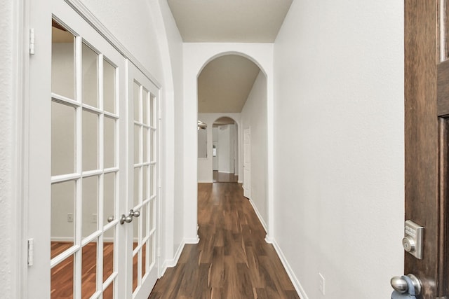 corridor with dark wood-type flooring and french doors