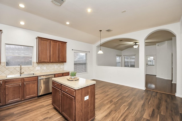 kitchen with pendant lighting, sink, stainless steel dishwasher, decorative backsplash, and ceiling fan