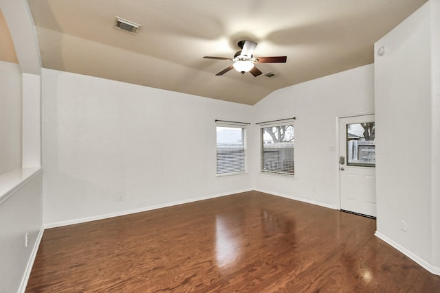 spare room featuring ceiling fan, dark wood-type flooring, and lofted ceiling