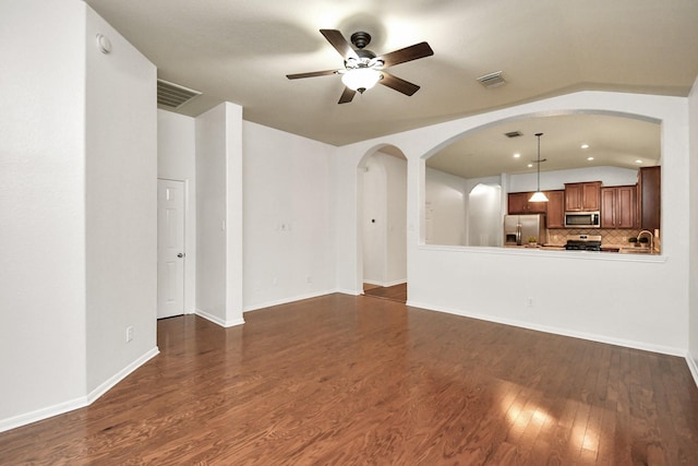 unfurnished living room with ceiling fan, dark hardwood / wood-style flooring, and lofted ceiling