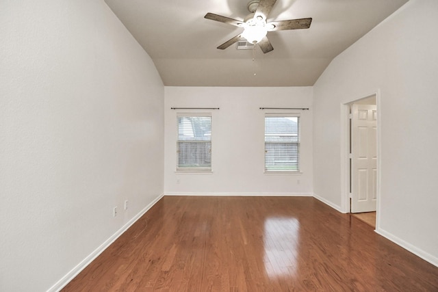 spare room featuring ceiling fan, dark hardwood / wood-style flooring, and lofted ceiling