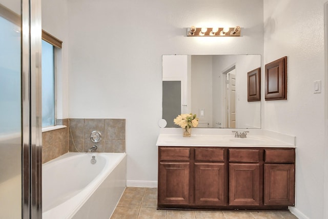 bathroom with tile patterned floors, vanity, and a bath