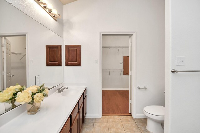 bathroom featuring tile patterned flooring, vanity, and toilet