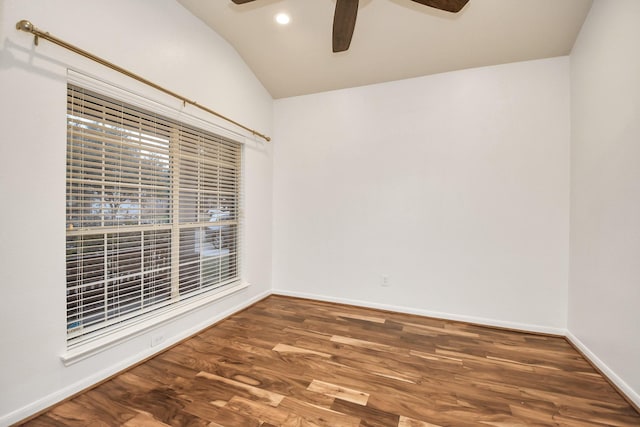 empty room featuring lofted ceiling and dark hardwood / wood-style floors