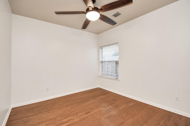 spare room with hardwood / wood-style flooring and ceiling fan