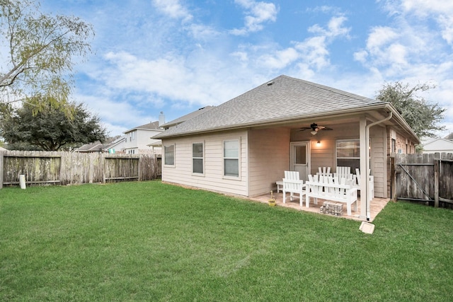 back of house with ceiling fan, a yard, and a patio