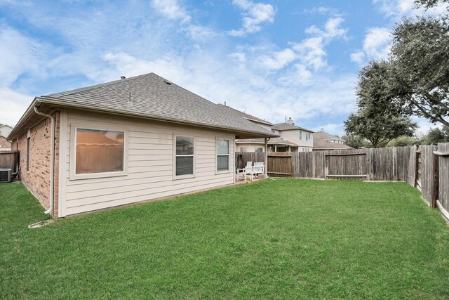 rear view of house featuring a lawn