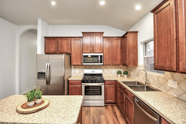 kitchen with light stone counters, sink, and stainless steel appliances