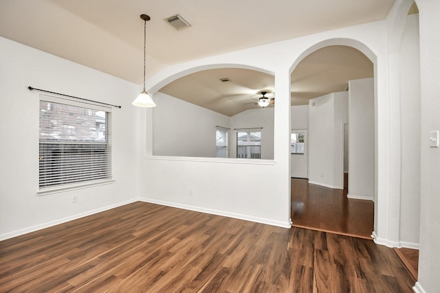 unfurnished dining area with dark hardwood / wood-style floors, ceiling fan, and vaulted ceiling