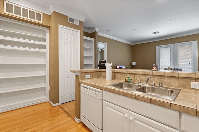 kitchen featuring white cabinets, ornamental molding, sink, light hardwood / wood-style flooring, and dishwasher