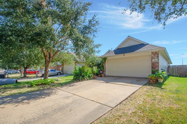 view of front of house featuring a front yard and a garage