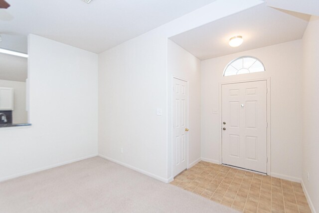 view of carpeted entrance foyer